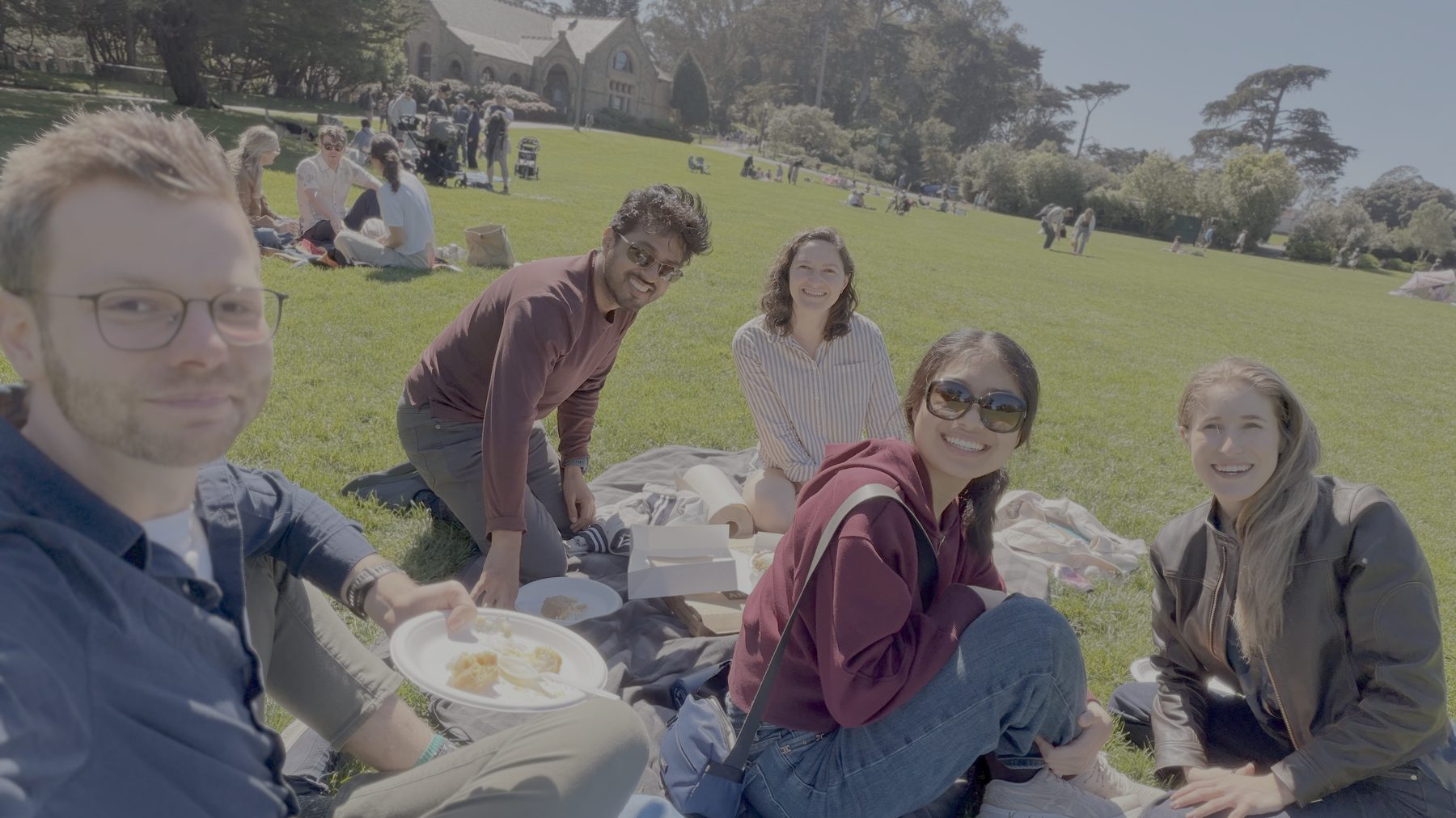 BayLeaf members sitting together on the grass at a summer picnic in a San Francisco park.